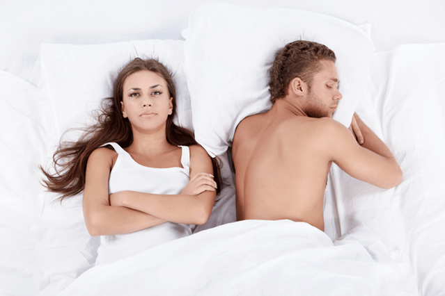 a woman in bed with a man of low potency